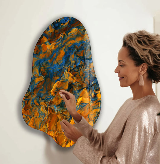 Vibrant blue and orange swirls explode with color saturation in this decorative glass wall art, a stunning abstract wall print.
