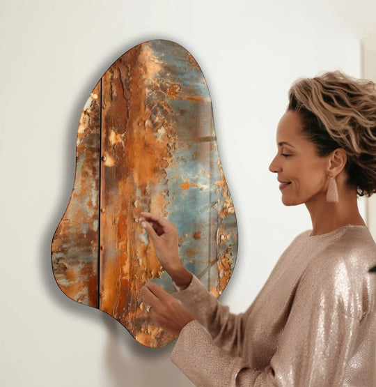A woman's hands touch the textured, layered surface of a rustic abstract best glass art piece.