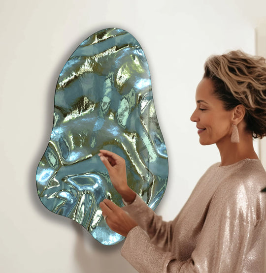 A woman admires a unique piece of decorative wall art, evoking a sense of awe and sophistication with its shimmering green abstract design.