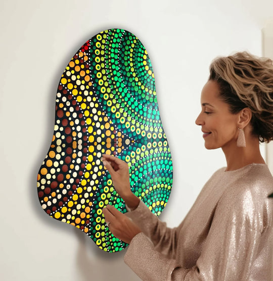 A woman admiring a vibrant green mosaic glass wall art piece, showcasing unique modern wall decor with quality craftsmanship.