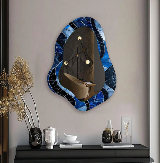 Cool color temperatures highlight the blue and black patterns of the stained glass wall mirror, enhancing its unique asymmetrical form as part of stylish glass wall art decor.