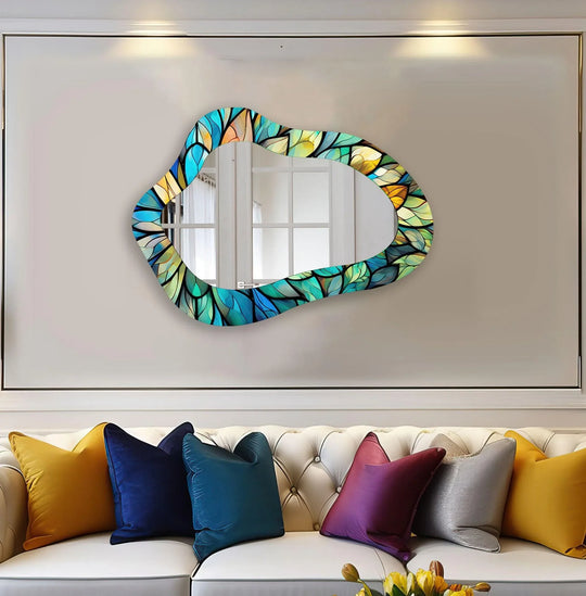 Featuring stained blue, green, and yellow hues, this leaf-patterned irregular wall mirror exemplifies modern wall mirrors as a striking home decoration.