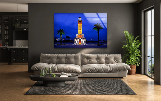 The softest element in this Izmir Clock Tower glass wall art is the cloud-like couch, complementing the stunning home decor featuring Turkey’s iconic landmark at night.