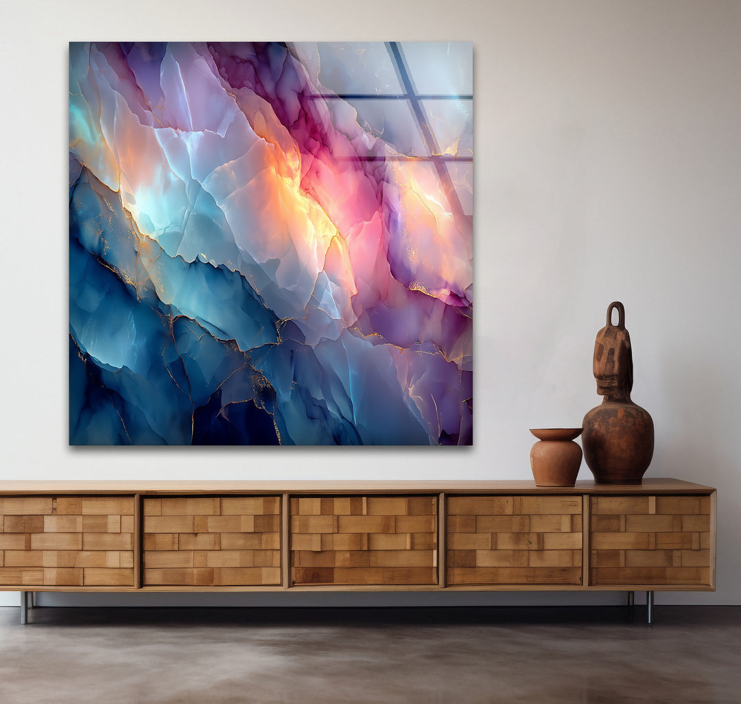 The sharp edges of this vibrant abstract marble art from glass showcase flowing blue, pink, and gold tones, reflecting subtle light.