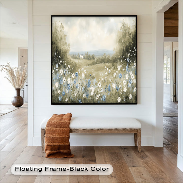 A tranquil field of soft-hued wildflowers surrounded by trees, opening up to a panoramic view of hills and distant cottages.
