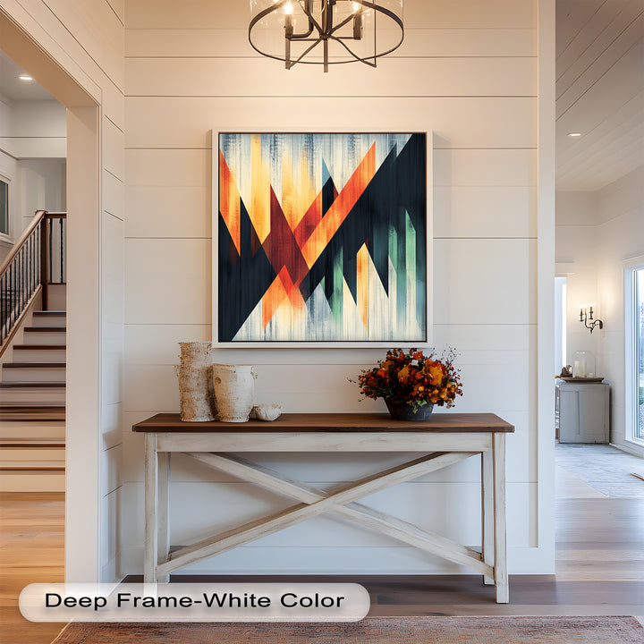 Modern wall art featuring intersecting triangles in vibrant orange and teal.
