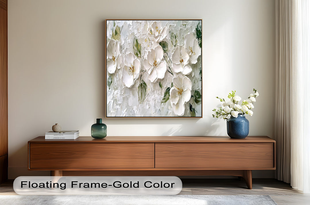 Elegant white flower wall art featuring rich texture and natural green accents.
