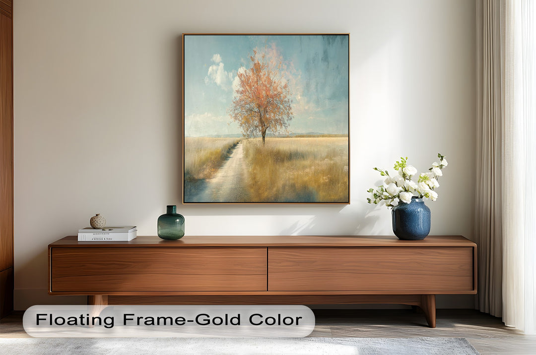 Golden field painting with single fall tree under peaceful sky.
