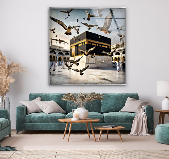 Light and shadow play across the Kaaba with doves in this peaceful flight scene captured in luminous glass wall artwork, highlighting the spiritual essence.