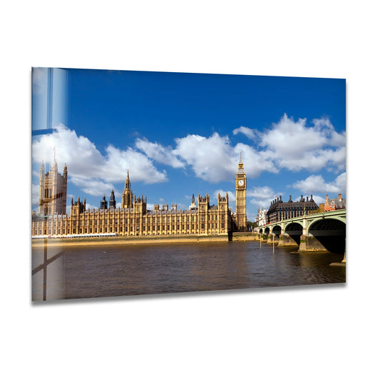 Billowing clouds create a soft backdrop for this Big Ben and Westminster glass wall art, an iconic London landmark perfect for home decoration.