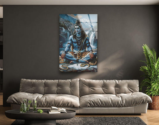 The stillness of Lord Shiva in blue, captured in a stunning tempered glass wall art, emanates peace amid a background of cascading waterfalls.
