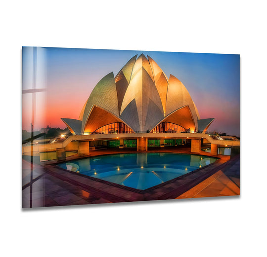 The geometric elements of this Lotus Temple glass wall art showcase the temple's petal-like forms and reflecting pool in a radiant sunset, adding distinctive home decor to any space.