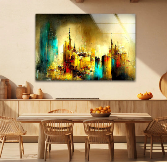 A rectangular glass art print showcases a dynamic, abstract cityscape with bold golden and teal shapes.