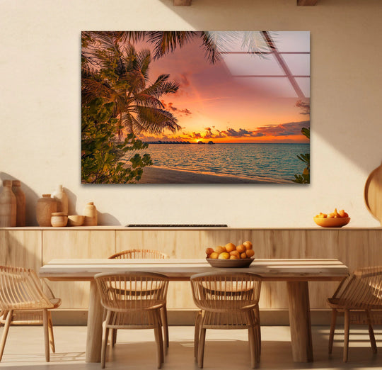 Visual rhythm is created by the repeating lines of the palm fronds and ocean waves in this tropical sunset beach scene, showcasing the best glass art print.