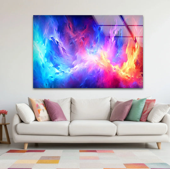 A white couch with colorful accent pillows sits in front of a vibrant glass wall artwork depicting abstract flames.