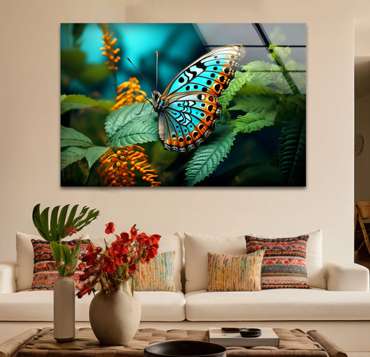 A sapphire and orange butterfly's wings create a dynamic visual rhythm on a glass art painting with lush green foliage.