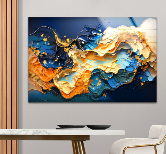 Abstract blue and gold fluid wave glass hanging wall art with shimmering gold accents.