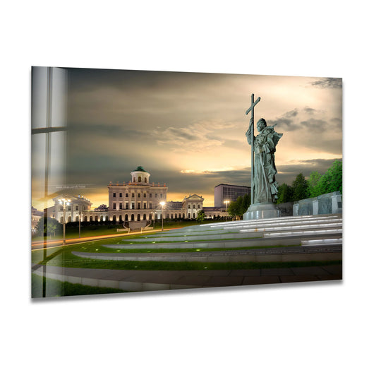 Evoking a serene mood, this monument to Saint Cyril and Saint Methodius glass wall art reflects the best glass art amid a dramatic sunset sky over an iconic landmark.