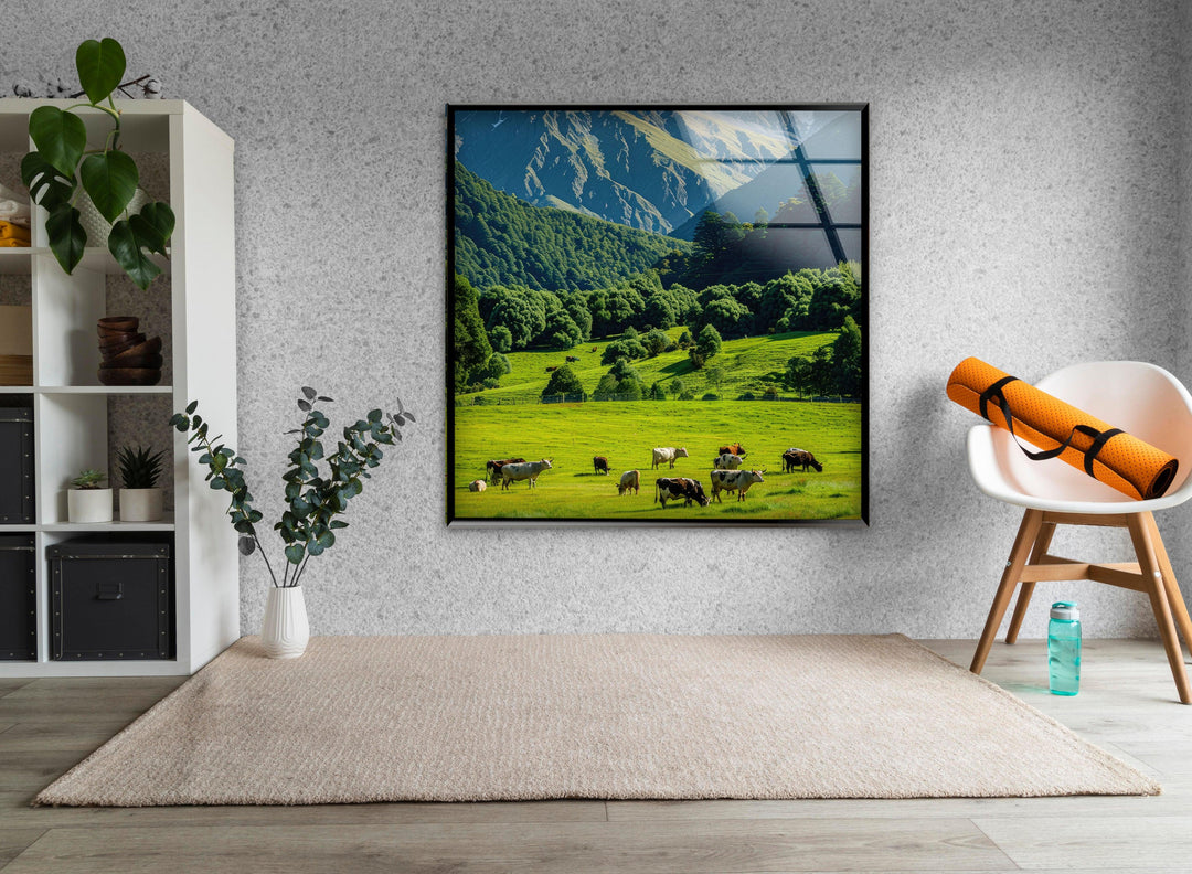 A picturesque meadow at the foot of majestic mountains, bathed in natural sunlight.

