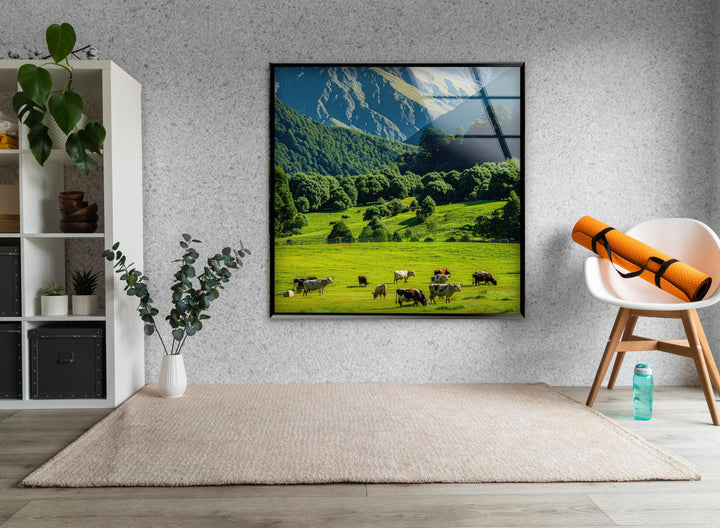 A picturesque meadow at the foot of majestic mountains, bathed in natural sunlight.
