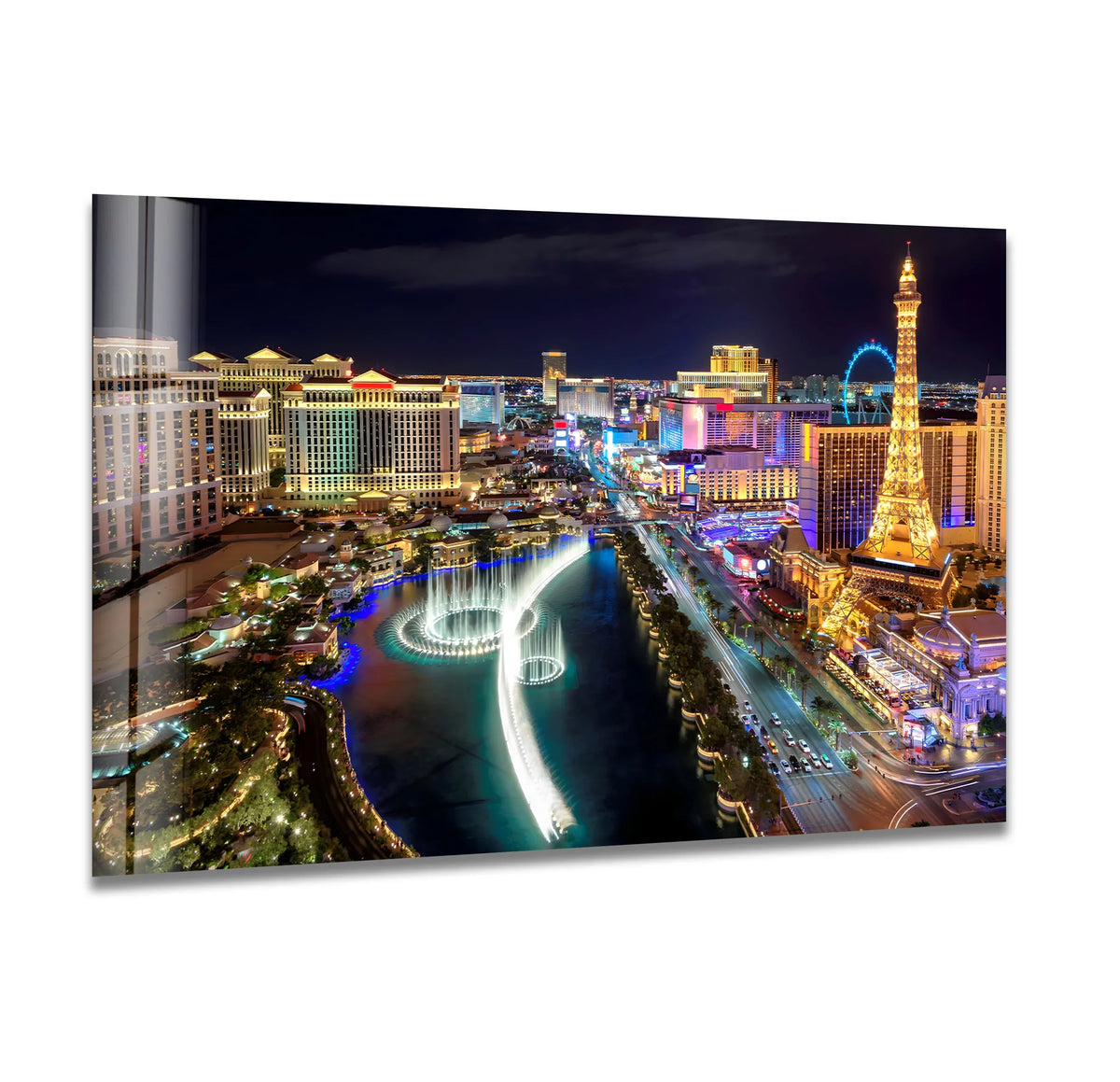 With vibrant color saturation, the illuminated Las Vegas strip glitters in this glass wall art, a unique modern wall decor piece showcasing the iconic skyline and Bellagio fountains at night.