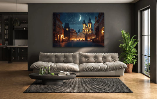 Foreground details of a round coffee table with drinks and a book complement the 'Night Old Town Square in Prague' hanging wall art, enhancing the room's aesthetic.