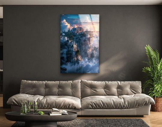 Central subject of mount Olympus glass wall art on a gray wall above a couch showcases stunning wall art prints of ancient Greek architecture and an ethereal, cloud-covered landscape.