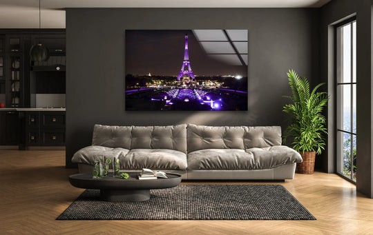 Lime-infused water and an open book sit on a round table, showcasing the foreground detail of this Eiffel Tower decorative wall art capturing an illuminated Paris landmark.