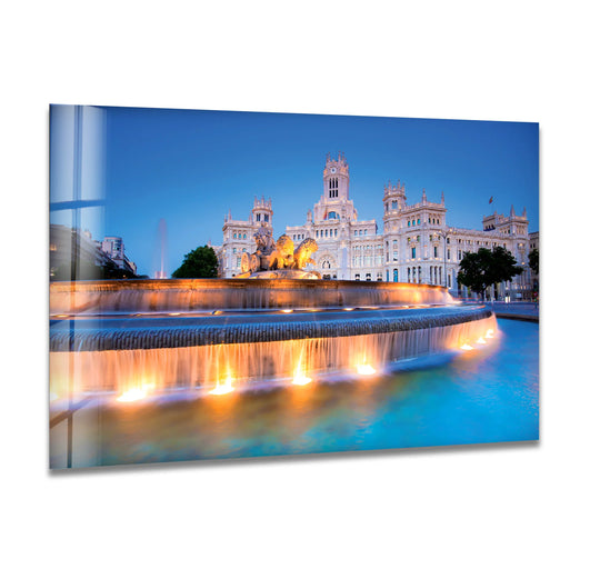 The stillness of twilight captures Madrid's Cibeles Fountain home decor reflecting the illuminated landmark in a tranquil glass wall art print.