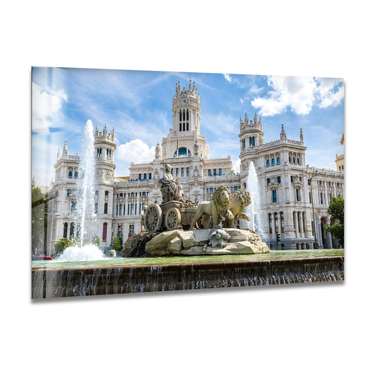 Sharp color contrast highlights the Cibeles Fountain glass printing wall art, showcasing Madrid's majestic landmark against a bright, cloudy sky.
