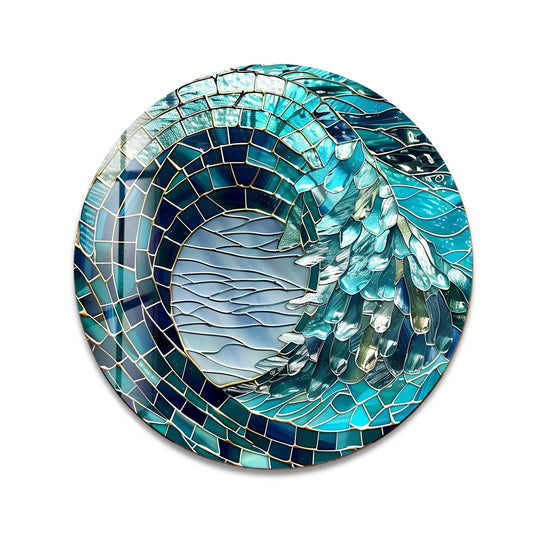 Featuring the textured edge and mosaic borders, this round ocean crest glass art depicts a captivating turquoise wave, enhancing its coastal aesthetic with shimmering glass art.