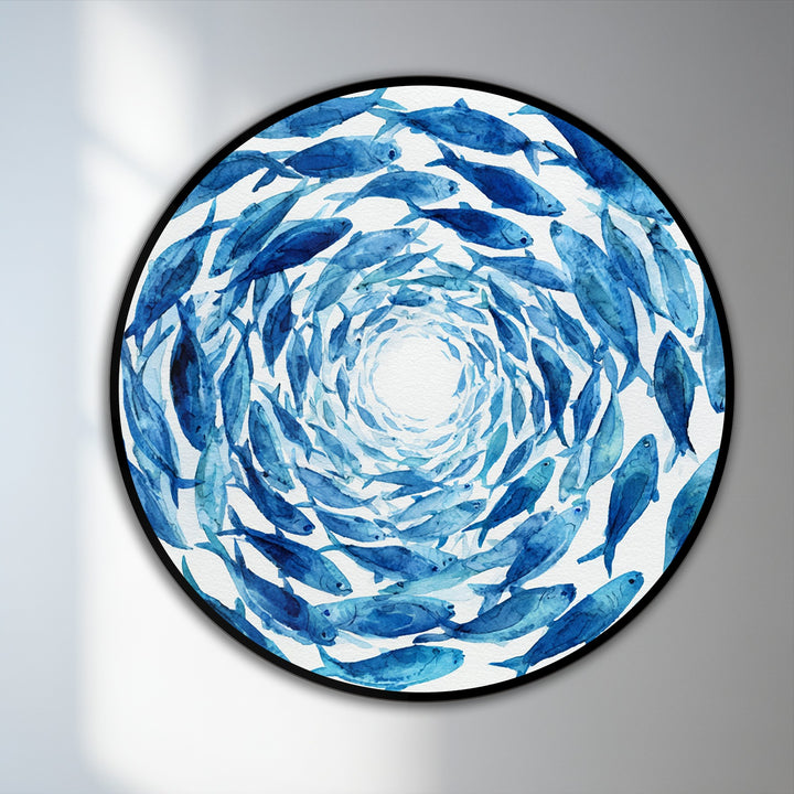 Gradual shading highlights the transition from a white center to deep blue hues in this round oil painting art piece of a blue spiral school of fish on wood.