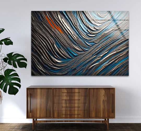 Dark, textured lines flow abstractly across this glass art, showcasing deep blues and sharp metallic contrasts.