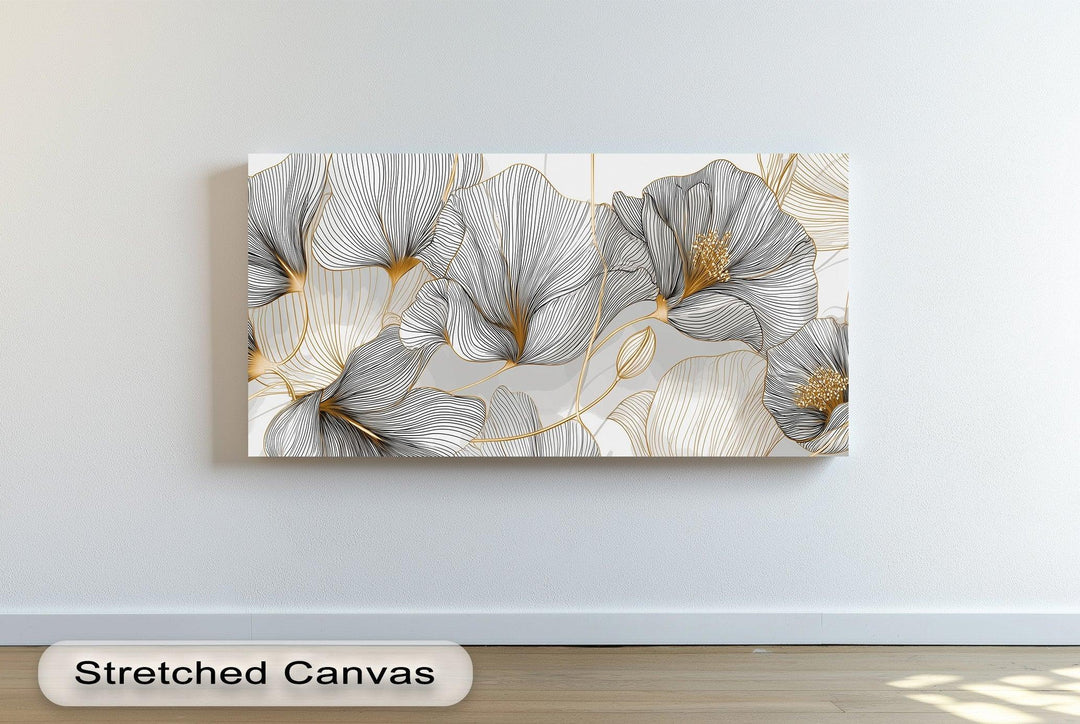 Minimalist floral canvas print with black and gold line art on white background

