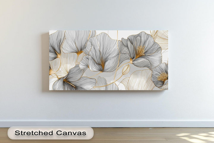 Minimalist floral canvas print with black and gold line art on white background


