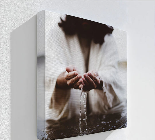 Neutral tones define this 'Living Water' canvas wall art, where Jesus' hands cupping water create a serene focal point in this spiritual canvas wall art piece.
