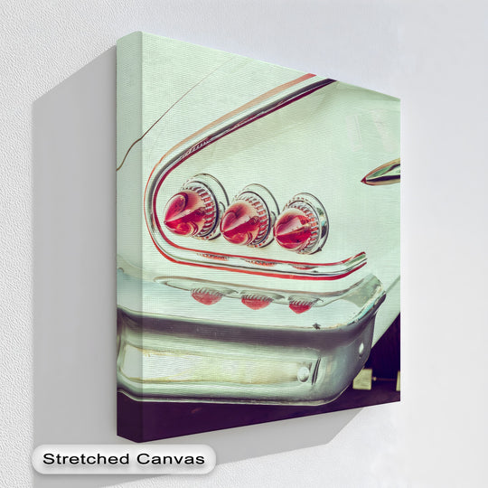 Transitioning hues highlight the dynamic contrast between red tail lights and cool chrome fins in this automotive canvas pictures print.