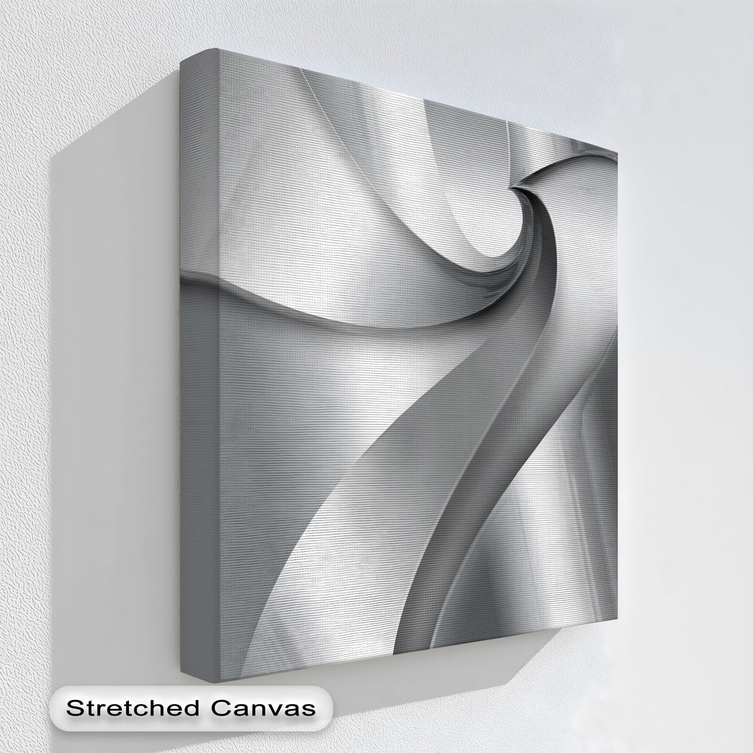 Overlapping silver and gray layered forms create a dynamic, abstract canvas wall decor with subtle gradients.
