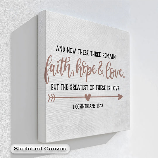 With warm hues, this hanging canvas presents a Faith, Hope & Love Christian print, displaying the scripture from 1 Corinthians 13:13 with comforting color temperature.