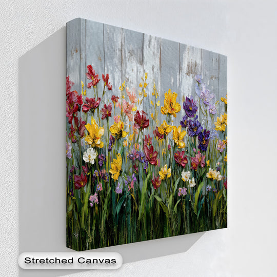 Vibrant color contrast highlights this rustic fence flower canvas print, a beautiful piece of canvas wall decor showcasing red, yellow, and purple wildflowers.
