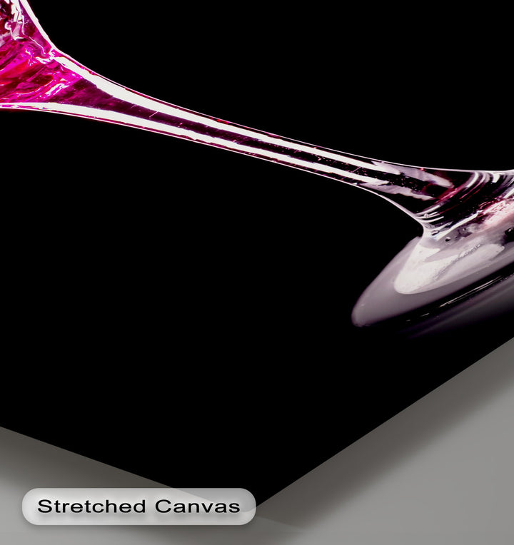 The solid black background dramatically highlights the vivid pink martini splash from a sleek glass, making glamorous hanging canvas art.