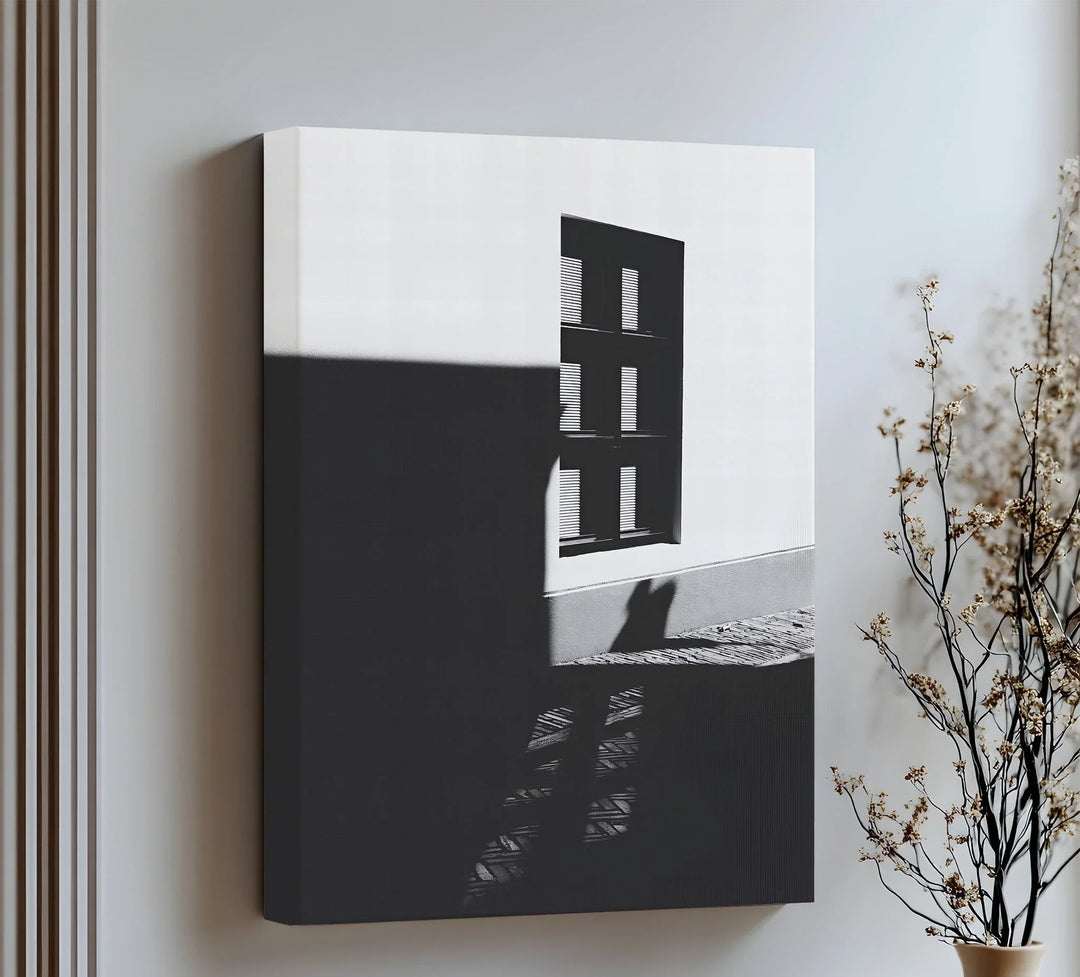 Clean lines and high contrast define this striking canvas wall art of light and shadow.

