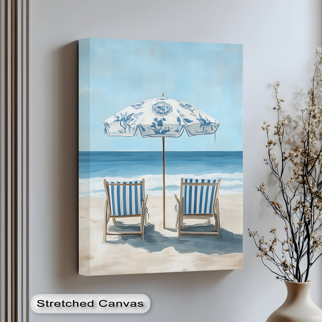 Relax by the waves with this serene canvas wall art of striped chairs and ocean breeze.

