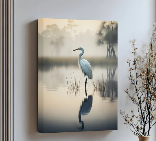 Neutral-toned canvas art prints show a tranquil heron in a misty lakeside scene, its reflection mirrored in the calm water, creating a peaceful, monochromatic effect.