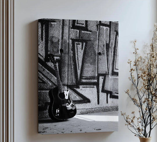 Acoustic guitar leans into the graffiti, bringing a sense of movement to this black and white hanging canvas urban contrast guitar art print.