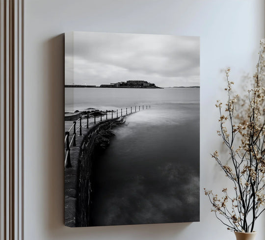Vertical rectangular canvas art prints showcase a monochrome coastal scene of a walkway leading to an island.