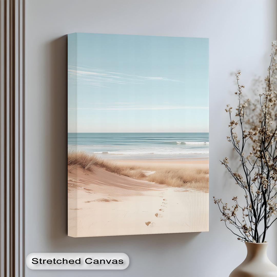 Bring calm to your space with this minimalist canvas print of sandy shores and gentle waves.

