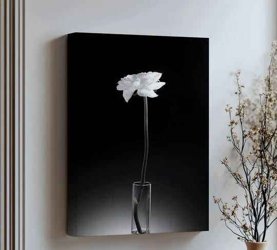 Highlighting the edge and borders of this high quality canvas prints showcases a minimalist white flower in a vase, creating a visually striking piece of wall art.