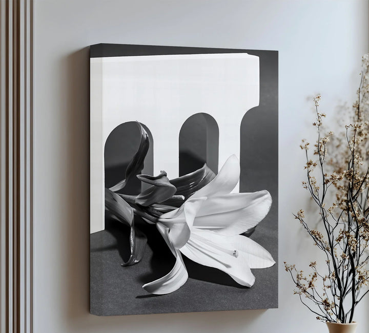 This minimalist canvas wall art pairs sculptural forms with a delicate lily for modern elegance.

