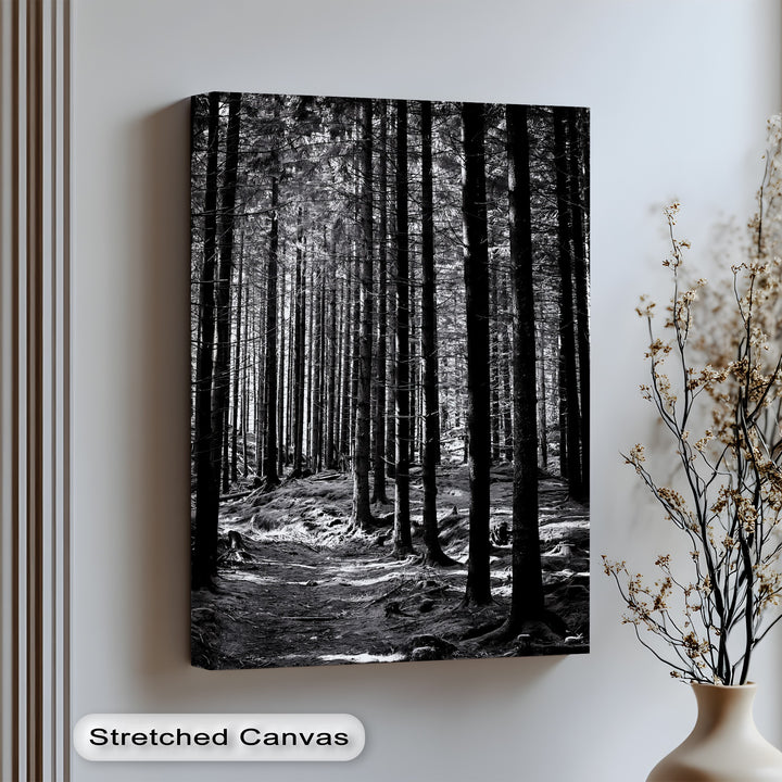 Step into quiet solitude with this striking canvas wall art of a black-and-white pine forest.

